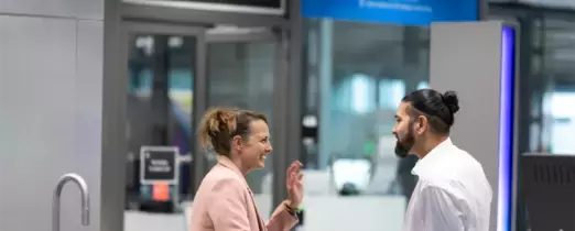 Colleagues chatting at coffee area 
