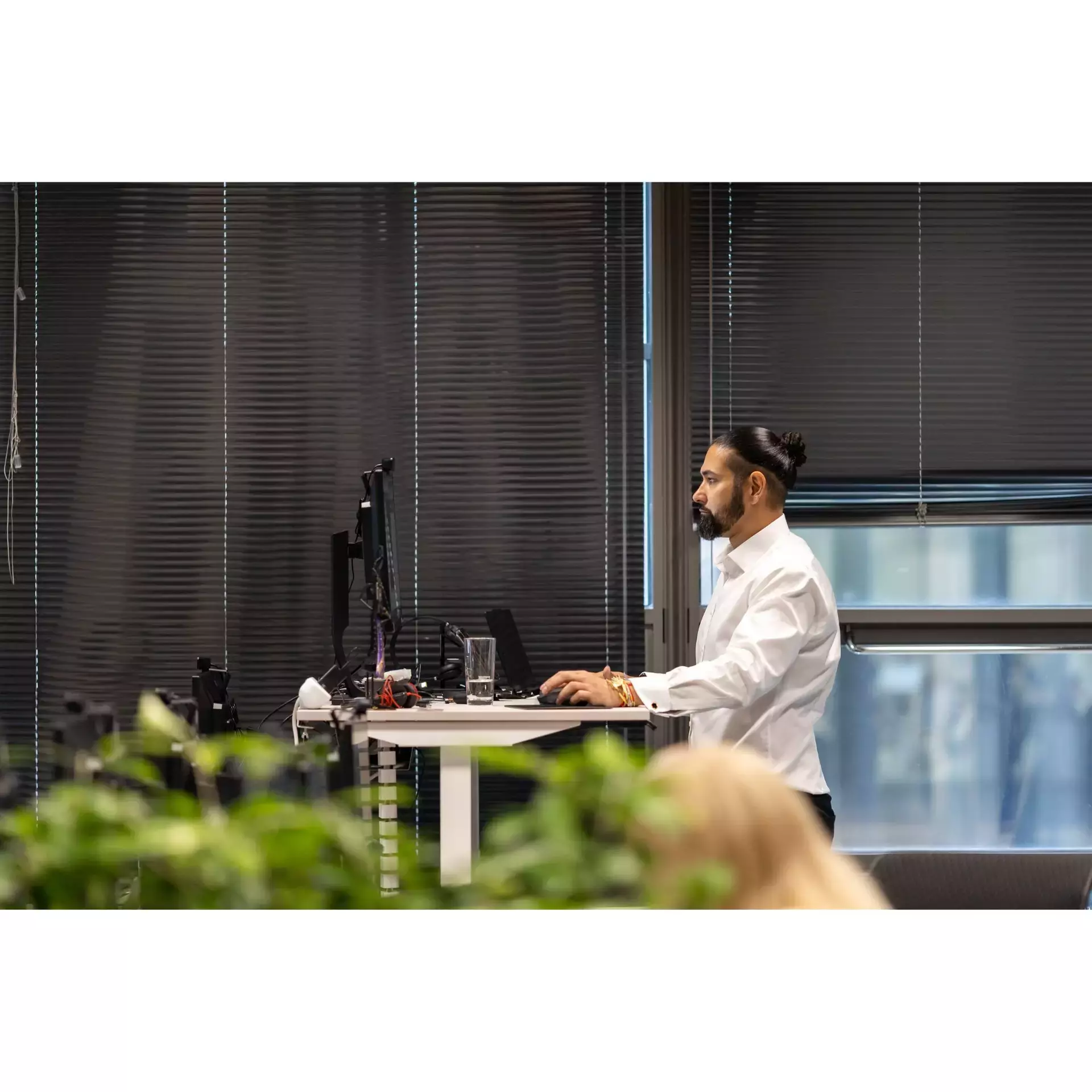 man standing and looking at screen