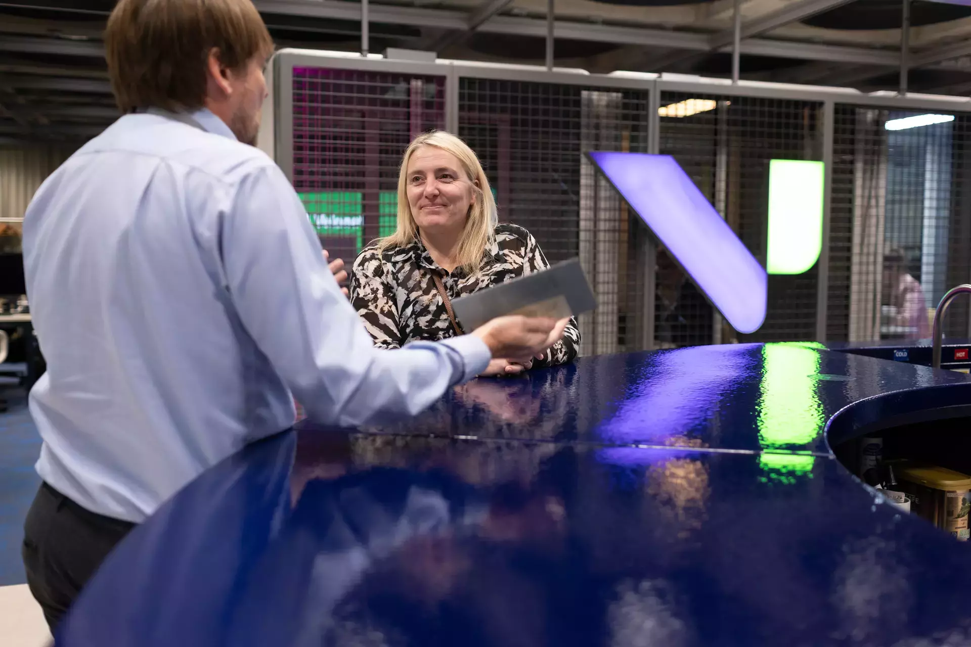 people_colleagues_chatting_at_coffee_area.