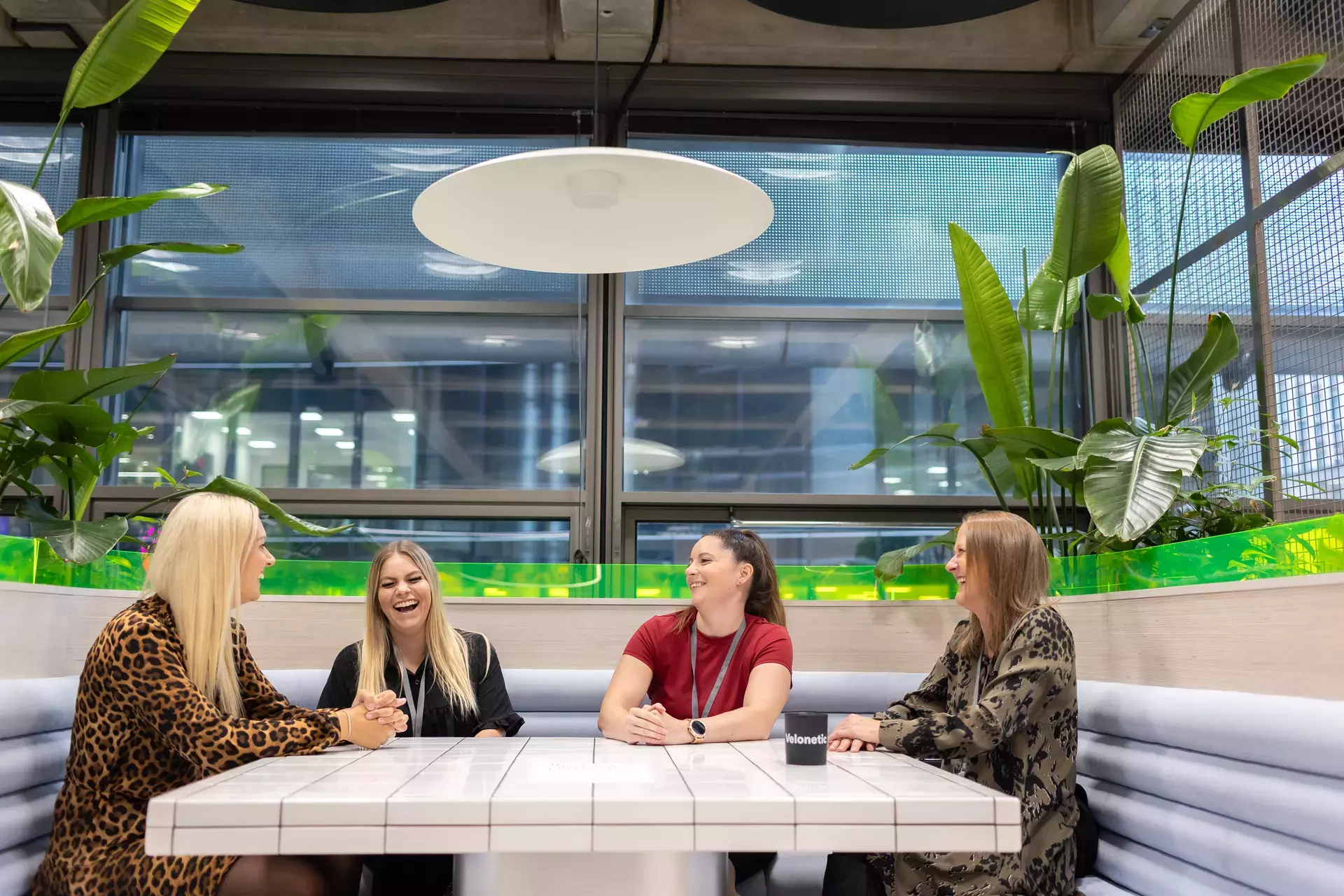 people_colleagues_laughing_sitting_in_communal_areas