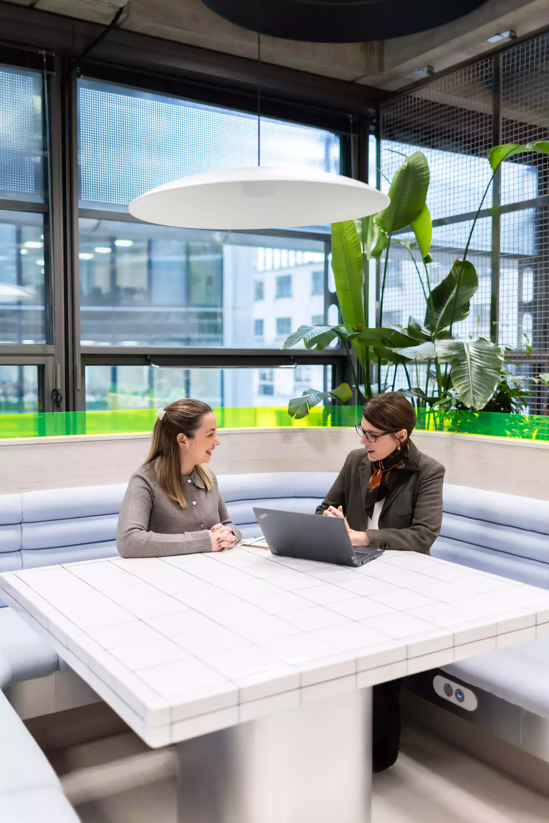 people_colleagues_talking_sitting_in_communal_area