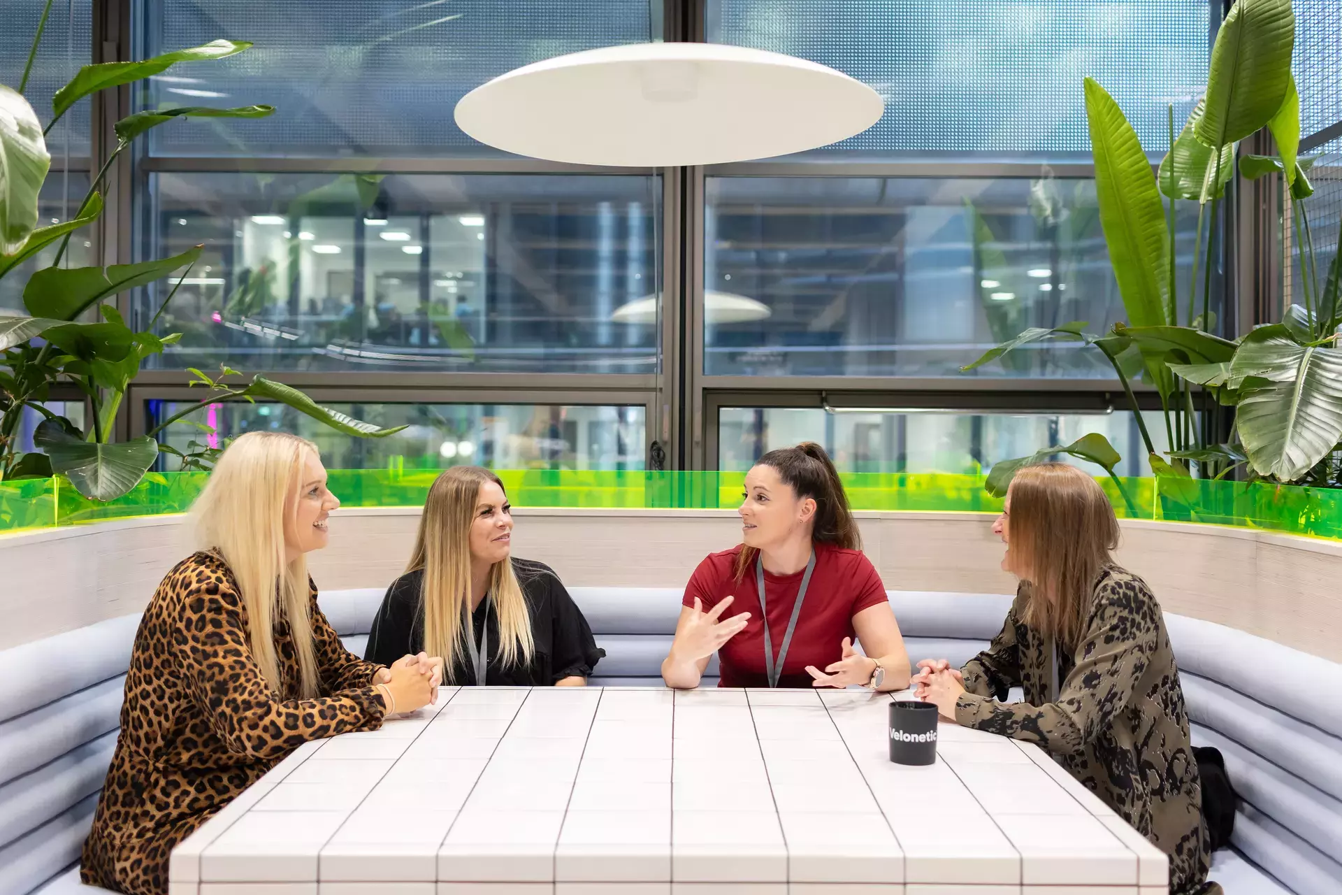 people_colleagues_talking_together_in_communal_area