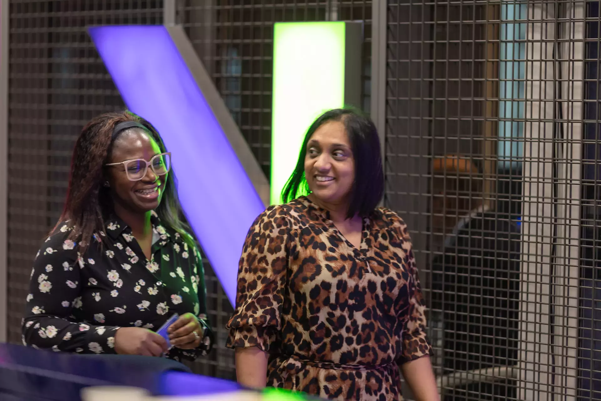 people_colleagues_walking_and_talking_infront_of_logo