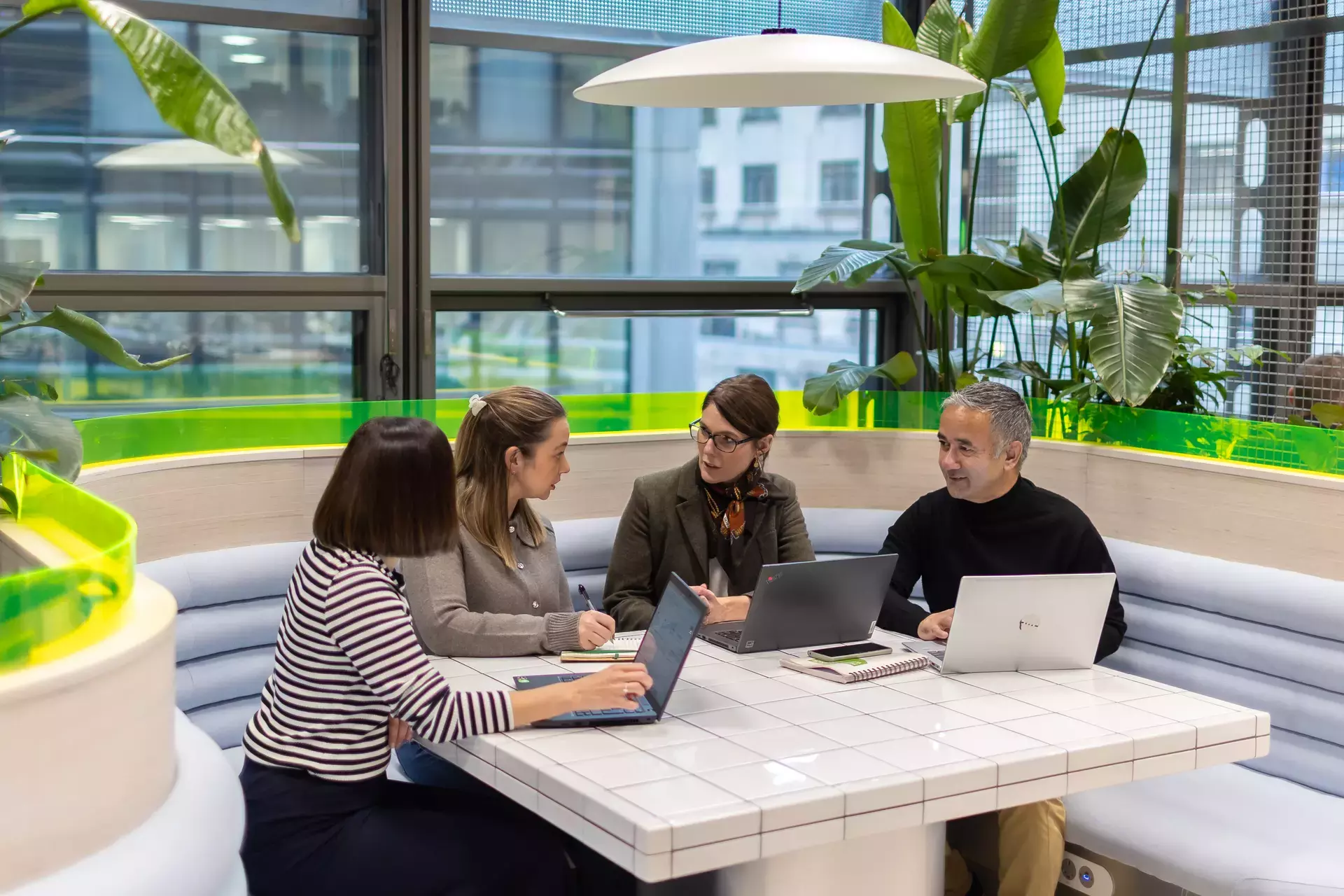 people_colleagues_working_on_laptops_together_in_communal_areas