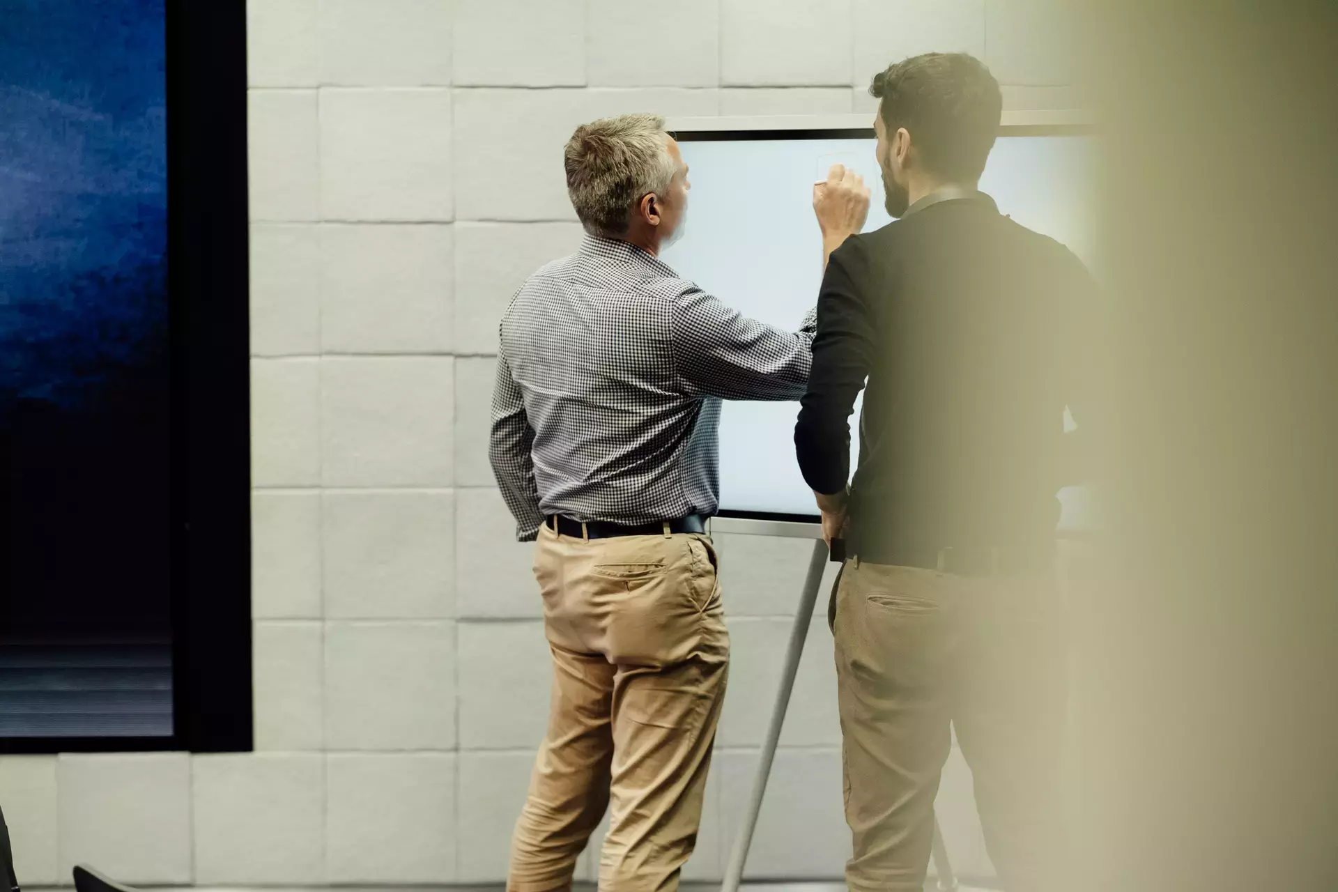 two people at a whiteboard 